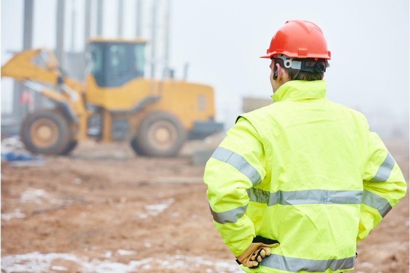 an image of a construction worker monitoring and supervising the construction operations at a construction site
